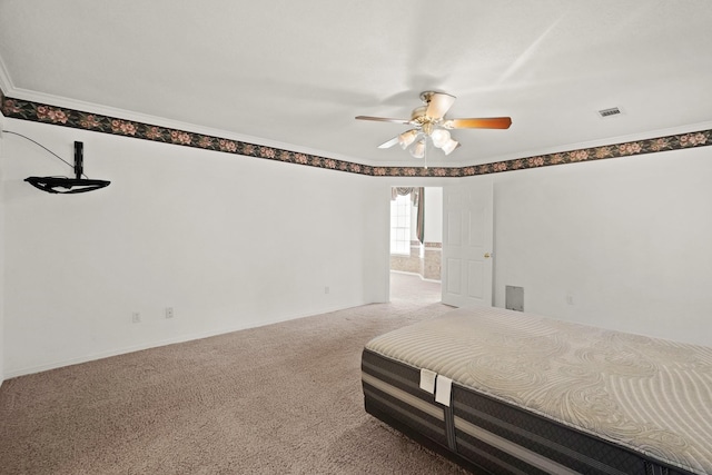 bedroom featuring visible vents, ceiling fan, baseboards, carpet floors, and ornamental molding