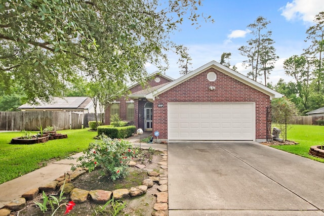 view of front facade with fence, concrete driveway, a front yard, and brick siding
