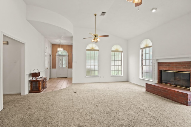unfurnished living room with visible vents, plenty of natural light, a ceiling fan, and carpet floors