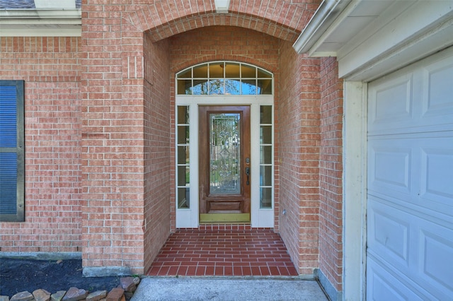 doorway to property with a garage