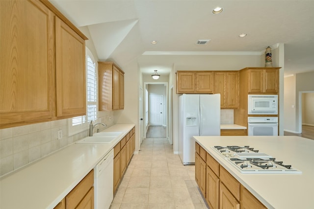 kitchen with white appliances, sink, ornamental molding, and decorative backsplash