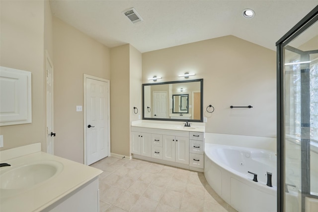 bathroom featuring a bath, tile patterned flooring, vaulted ceiling, and vanity