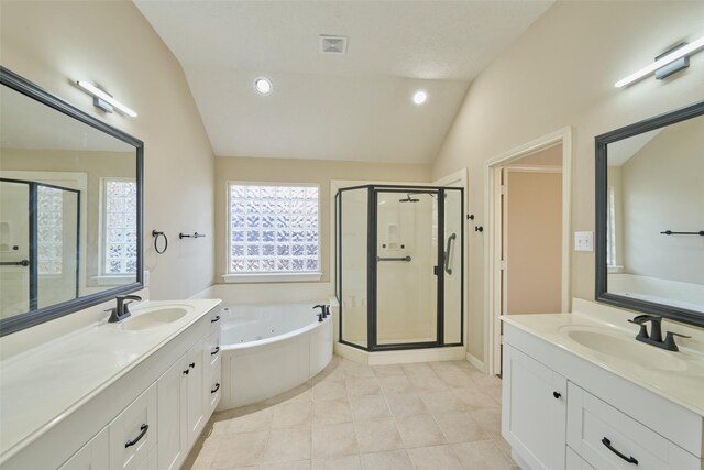 bathroom with independent shower and bath, vanity, tile patterned flooring, and vaulted ceiling