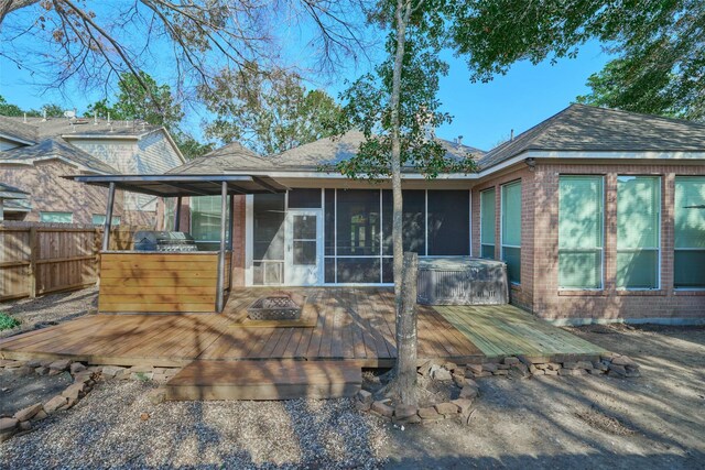 back of property featuring a deck and a sunroom