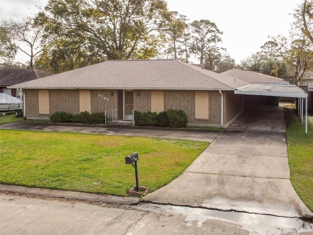 view of front of house with a front yard and a carport