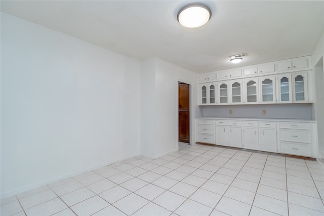 kitchen featuring white cabinets and light tile patterned floors