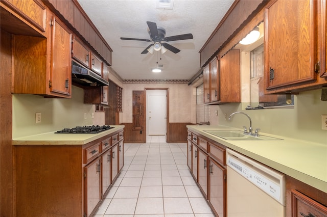 kitchen with a textured ceiling, ceiling fan, light tile patterned floors, dishwasher, and stainless steel gas stovetop