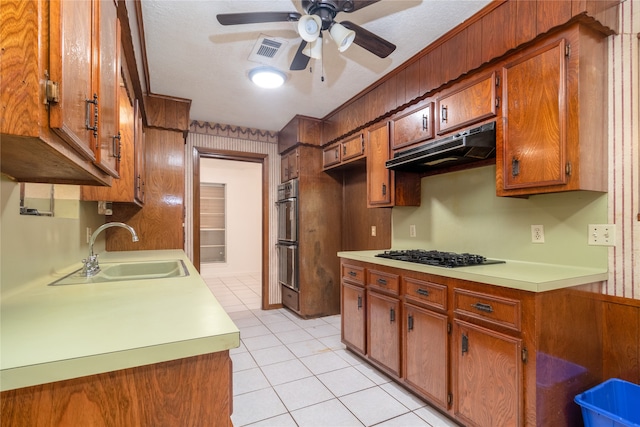 kitchen with black gas stovetop, a textured ceiling, ceiling fan, sink, and light tile patterned floors