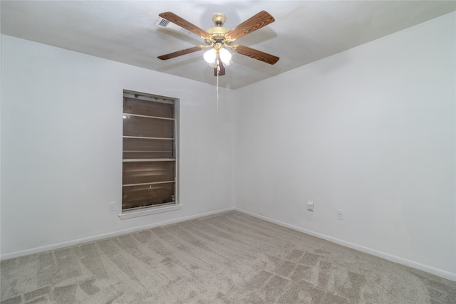 carpeted spare room with ceiling fan