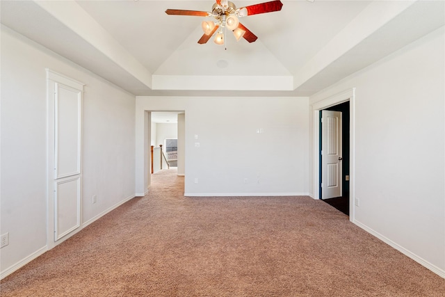 unfurnished room with a raised ceiling and carpet floors