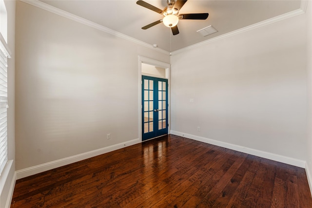 empty room featuring french doors, ornamental molding, and dark wood-type flooring