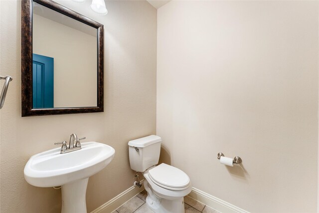 bathroom with tile patterned flooring and toilet