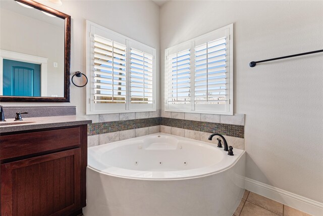 bathroom featuring vanity, tile patterned floors, and a bathing tub