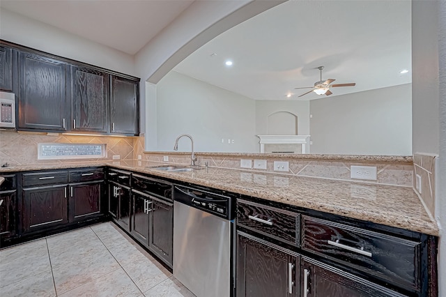 kitchen featuring ceiling fan, sink, light stone countertops, and stainless steel appliances