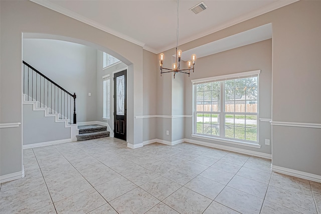 foyer featuring light tile patterned floors, crown molding, and a notable chandelier