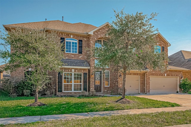 view of front of house featuring a front yard and a garage