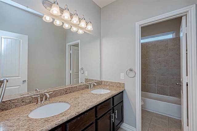 bathroom with tile patterned flooring, vanity, and tiled shower / bath combo