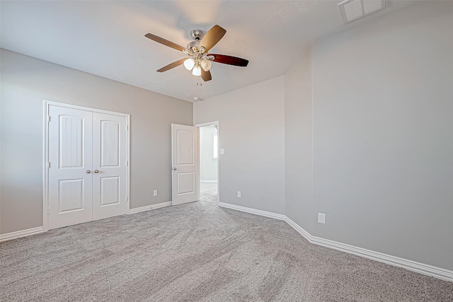 unfurnished bedroom featuring light carpet and ceiling fan