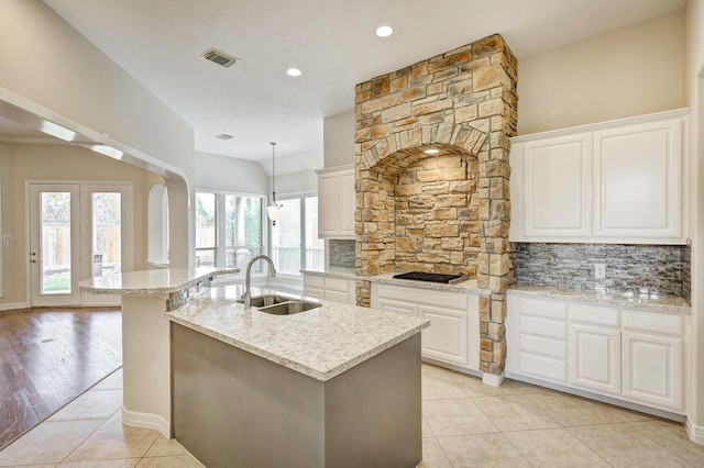 kitchen with white cabinetry, light hardwood / wood-style flooring, a healthy amount of sunlight, and sink