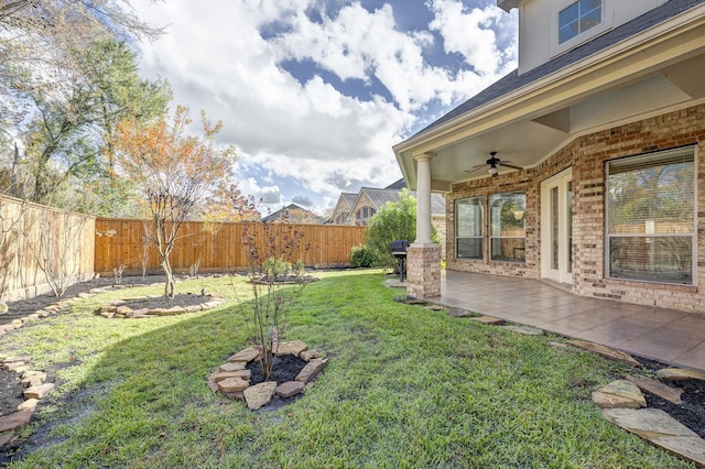 view of yard featuring ceiling fan and a patio area