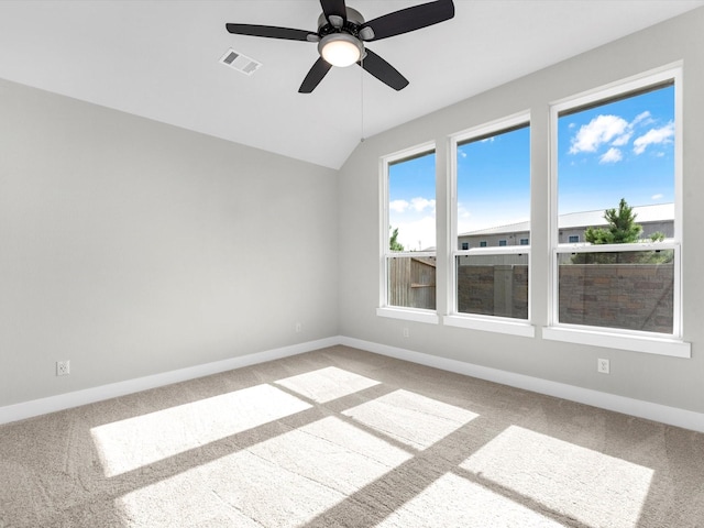 spare room featuring carpet flooring, ceiling fan, and lofted ceiling