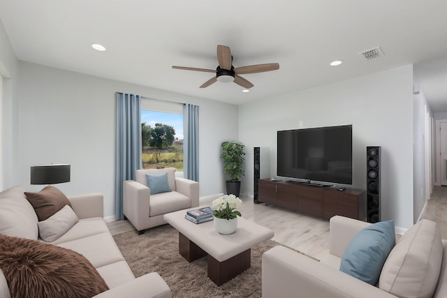 living room with light hardwood / wood-style floors and ceiling fan