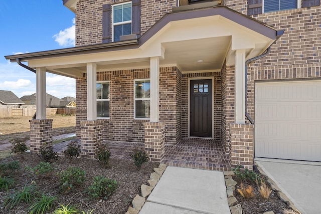 entrance to property featuring a garage and covered porch