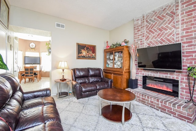 living room featuring carpet, a textured ceiling, and a brick fireplace