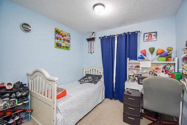 carpeted bedroom featuring a textured ceiling