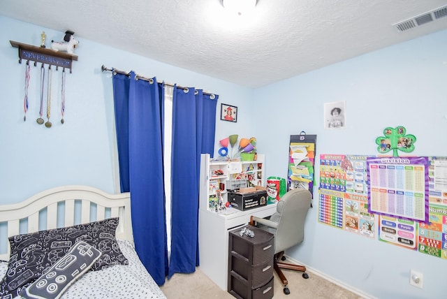 bedroom with carpet flooring and a textured ceiling