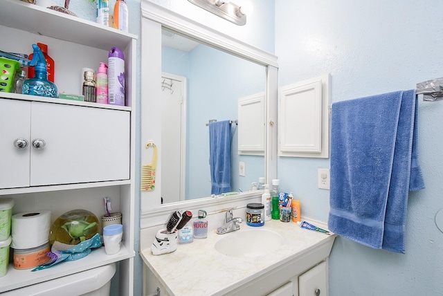 bathroom with vanity and toilet