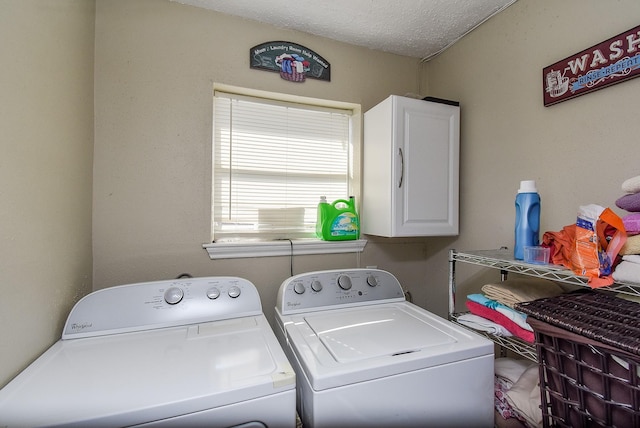 washroom with cabinets, separate washer and dryer, and a textured ceiling