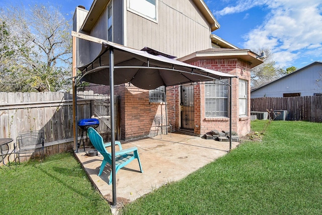 rear view of property with central AC unit, a patio area, and a yard