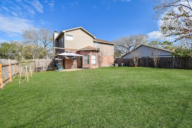 back of house featuring a patio area and a yard