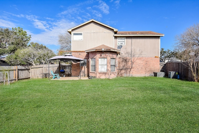 rear view of property with a gazebo, a yard, and cooling unit