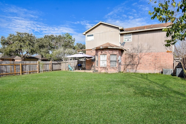 back of property with a lawn, cooling unit, and a patio area