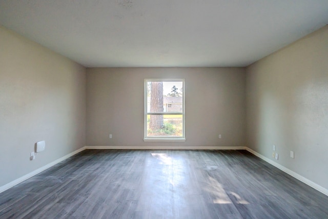 spare room with dark hardwood / wood-style floors