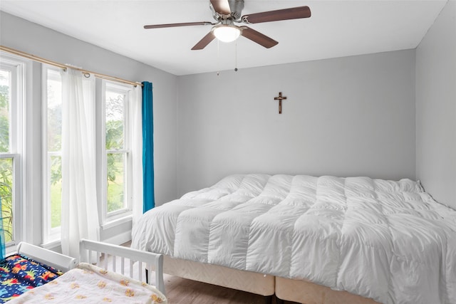 bedroom with hardwood / wood-style flooring and ceiling fan