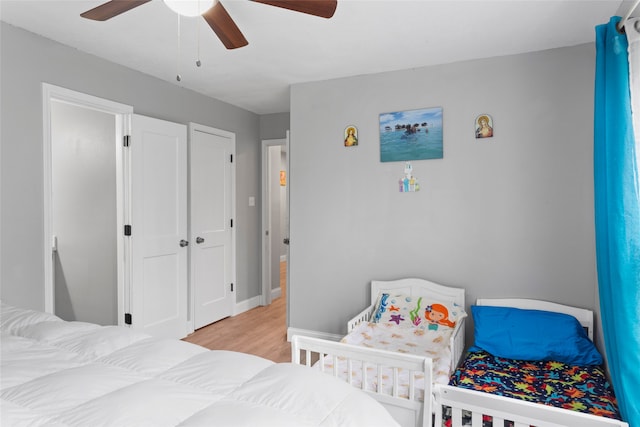 bedroom with a closet, ceiling fan, and light hardwood / wood-style flooring