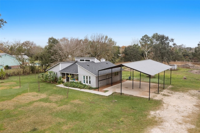 back of house featuring a yard and a carport