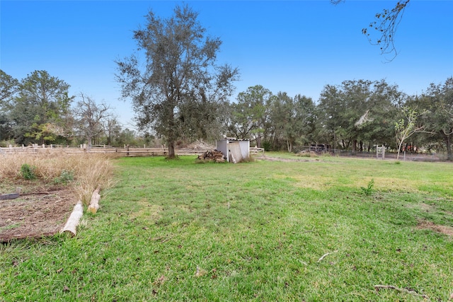 view of yard with a rural view and a shed