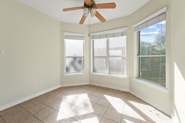 unfurnished room featuring ceiling fan and light tile patterned floors