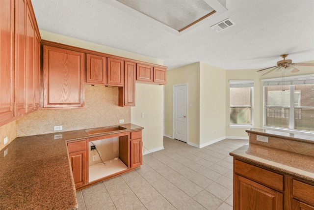 kitchen with tasteful backsplash, a textured ceiling, ceiling fan, electric cooktop, and light tile patterned flooring