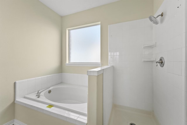 bathroom featuring shower with separate bathtub