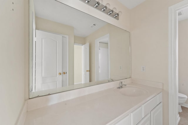 bathroom with vanity and toilet