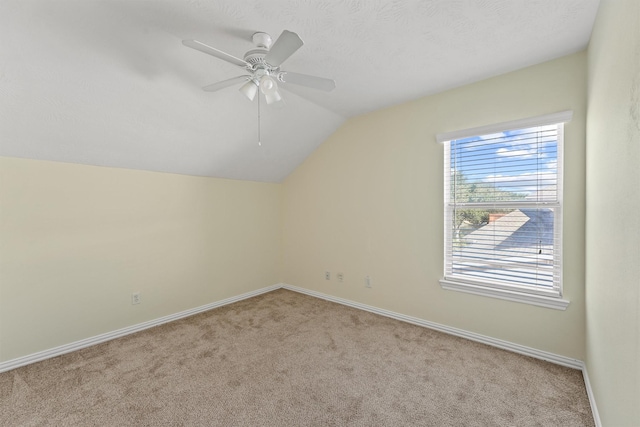 additional living space with light carpet, vaulted ceiling, and ceiling fan