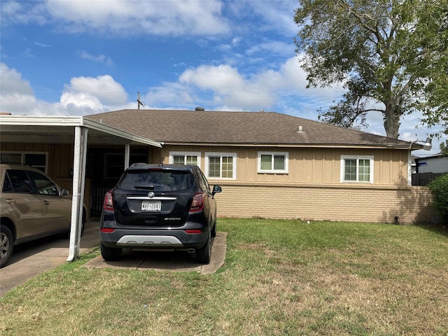 view of side of home with a yard and a carport