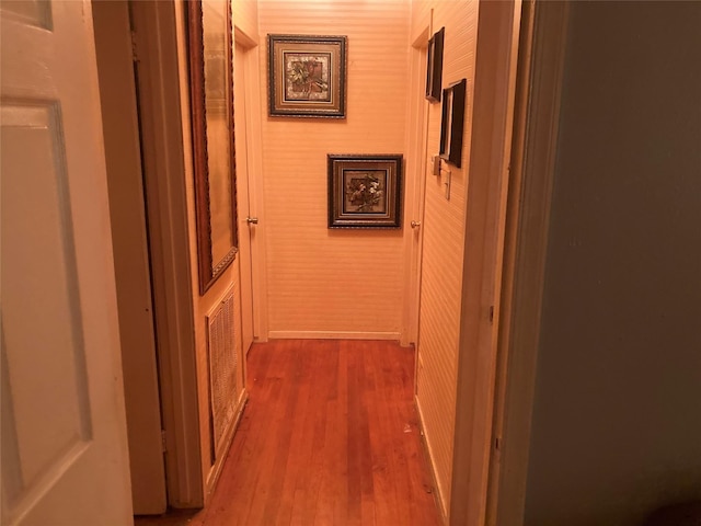 hallway with dark hardwood / wood-style flooring and wood walls