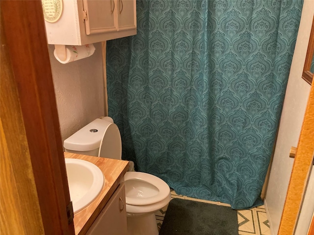 bathroom featuring vanity and toilet