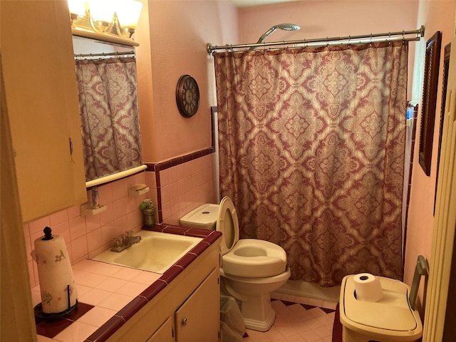 full bathroom with vanity, tile patterned flooring, toilet, shower / bathtub combination with curtain, and tile walls